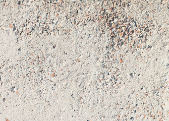 Concrete wall, white color with rocks. White concrete wall. Old concrete.