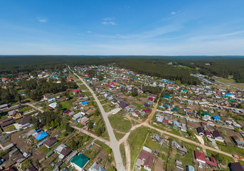 Sysert city. Russia. Aerial. City with low private houses and long streets. Sunny, summer