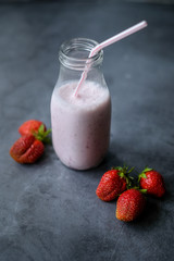 Bowl with red strawberries at dark wooden background,closeup