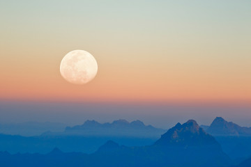 Mountains at sunset seen from the snowy Huaytapallana next to the moon, photography achieved thanks to the use of double exposure from the camera.