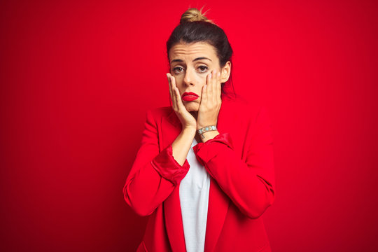 Young beautiful business woman standing over red isolated background Tired hands covering face, depression and sadness, upset and irritated for problem