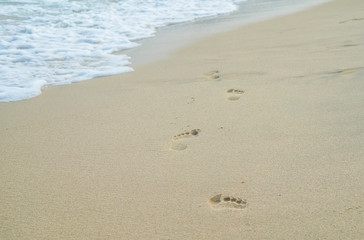 Fototapeta na wymiar Footprints on the sand on the beach