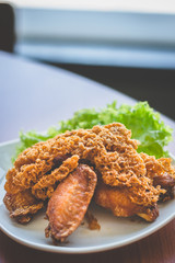Prawn paste crispy fried chicken served on lettuce leaf and white plate