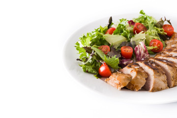 Grilled chicken breast with vegetables on a plate isolated on white background. Copyspace