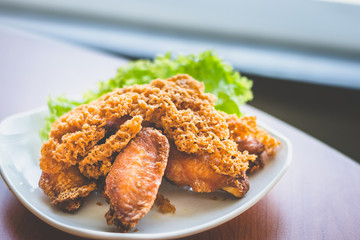 Prawn paste crispy fried chicken served on lettuce leaf and white plate