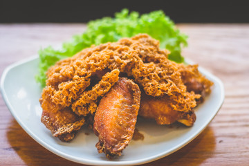 Prawn paste crispy fried chicken served on lettuce leaf and white plate