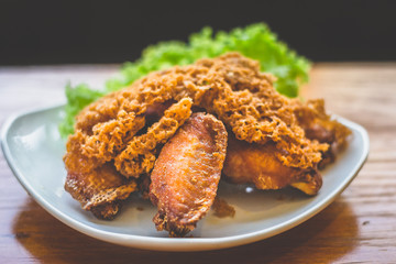 Prawn paste crispy fried chicken served on lettuce leaf and white plate