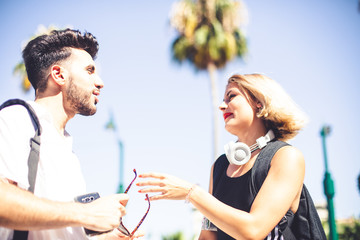 Lifestyle Photography. A blonde young girl and a young man relaxed in a sunny day in summer.