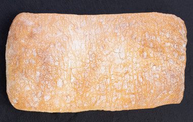 ciabatta bread on the dark background, top view