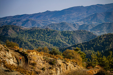 Naklejka premium A mountain biker riding along a dirt road in Cyprus