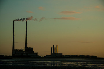 Poolbeg Gas/Oil Power Station seen from Sandymount strand, Dublin, Ireland. Early morning