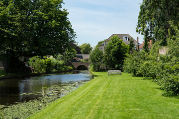 picnic table on grass field. Canal along the city walls in  fortified city Vianen, The Netherlands