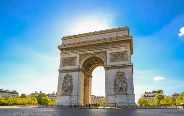 Fototapeta na wymiar Nice view of the Arc de Triomphe de l'Étoile, one of the most famous and popular monuments in Paris. The two pillars at the west façade shows the sculptures La Paix and La Résistance by Antoine Étex.