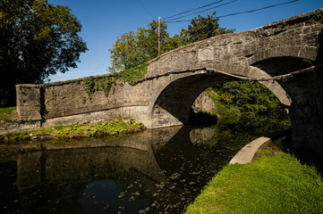 Fototapeta na wymiar Old stone road bridge over the Grand Canal, near Newcastle, County Dublin, Ireland