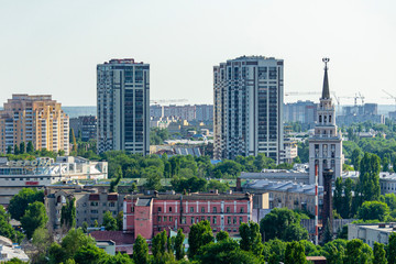 Fototapeta na wymiar View from window of skyscraper on two modern high-rise buildings against blue sky. Right close-up most famous high-rise is building ofSouth-Eastern Railway. Voronezh, Russia, June, 2019: 