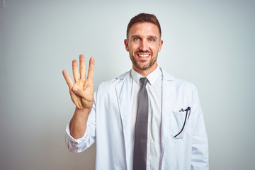Young handsome doctor man wearing white profressional coat over isolated background showing and pointing up with fingers number four while smiling confident and happy.