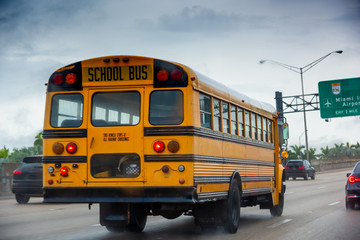 Obraz na płótnie Canvas School bus on the highway in Miami on a cloudy day