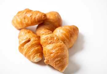 Various croissants stacked on white background. Isolated.