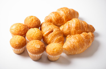 Various croissants and cupcakes on white background. Isolated.