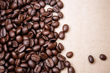 Coffee beans put at the left side of brown background,burry light around
