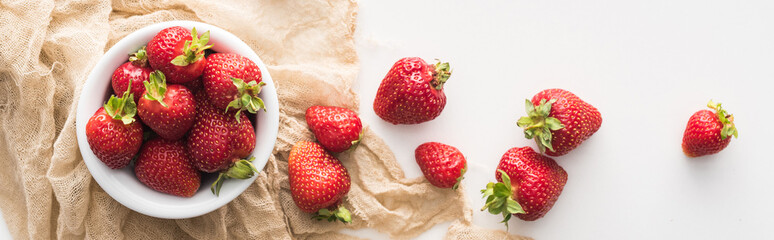 panoramic shot of fresh and ripe strawberries on white bowl with cloth