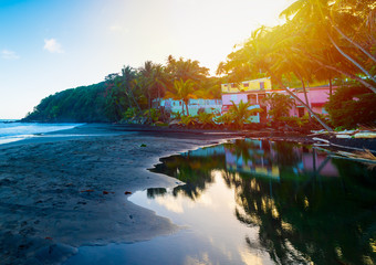 Sun shining over Grande Anse beach in Guadeloupe at sunset
