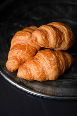 Croissants on metal tray. Vertical shoot.
