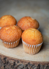 Close-up of cupcakes on wooden board. Sweets for breakfast. Vertical shoot.