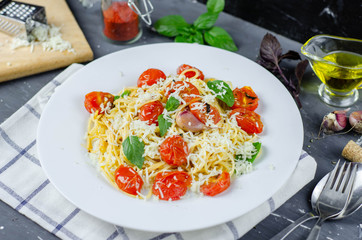 Fresh pasta with garlic Cherry Tomatoes and basil. Delicious Pasta Plate. Spaghetti. Italian food. Italy. Roma. Fine dining. Healthy food. Vegetarian. Healthy food