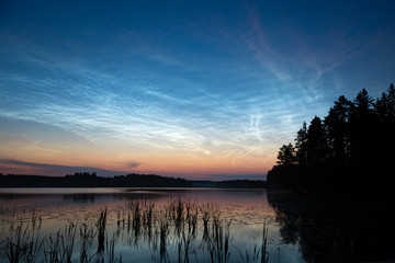 Night shining clouds over lake