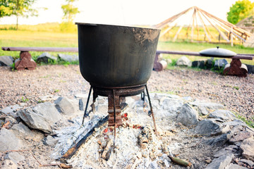 Cooking outside on the fire in a large cauldron