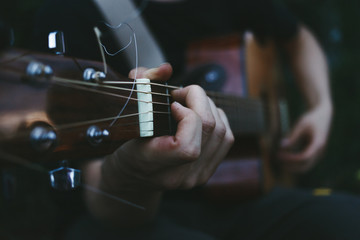 Man playing on guitar close up, playing guitar, musician, hand and fingers, music background