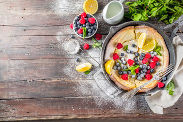 Sweet dutch baby pancake with fruit and berries