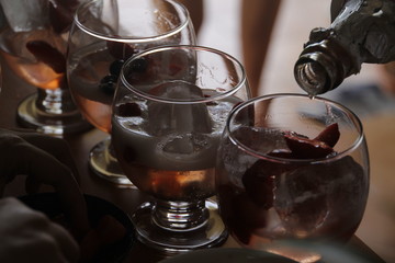 Pouring champagne in a cocktail during a party