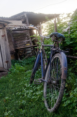 blue soviet bicycle near the wooden fence
