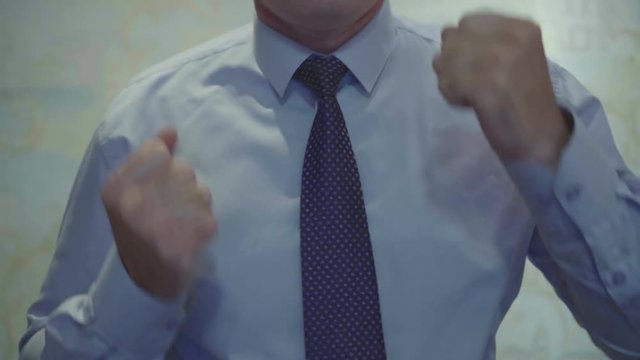 Businessman in a tie dancing for joy