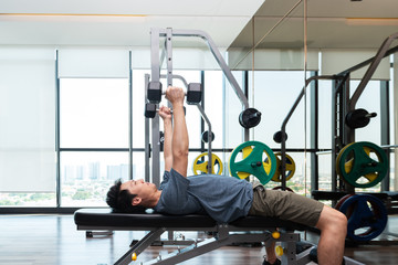 Fitness man are training or exercising by lifting dumbbells. in Fitness room at sport gym.