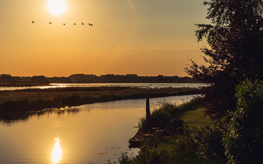 Splendid countryside landscape by the water before sunset, in summer - Groningen, Netherlands