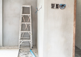 Home improvement concept with steel ladder and white wall in empty room