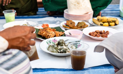 Ramadan iftar buffet with Thai food menu. Food set including palm date, sweet and drink. Peopel waiting time for fast breaking.
