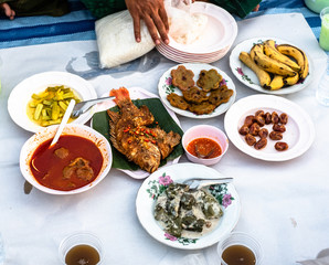 Ramadan iftar buffet with Thai food menu. Food set including palm date, sweet and drink. Peopel waiting time for fast breaking. Top view.