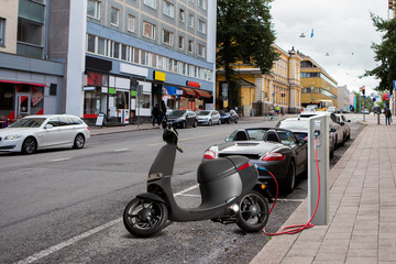 Electric scooter for sharing with charging station on a city street © scharfsinn86