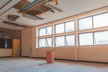 repair leak water pipe in under gypsum ceiling interior office building and bucket water