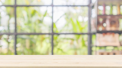 Empty wood table top with abstract blur coffee shop or cafe restaurant background with bokeh light...