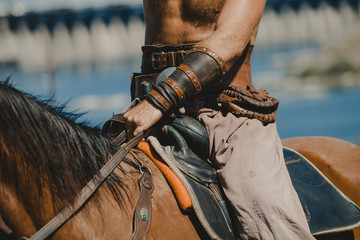 Cossack in trousers sits on horse