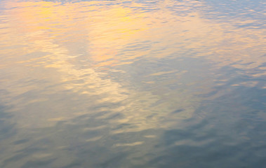Plakat Water ripple surface reflection effect from sunset and sky top view at lake in evening day,wave abstract background