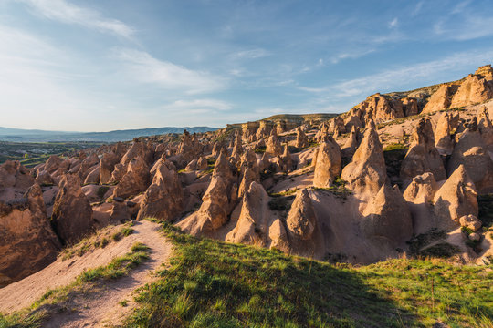 Rough stone formations located in wonderful valley on sunny day in Cappadocia, Turkey