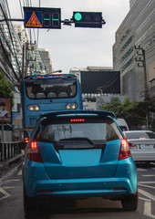 Cars stand at semaphore lights in the city streets. Traffic in downtown Bangkok, Thailand.