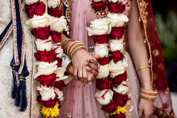 Detail of hands and clothing during Indian wedding ceremony.
