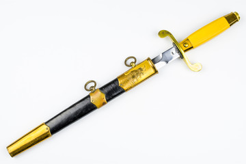Old dirk in black-yellow sheath isolated on a white background.